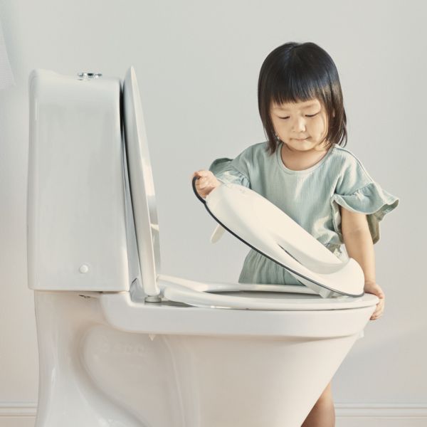 Réducteur de toilette blanc et noir